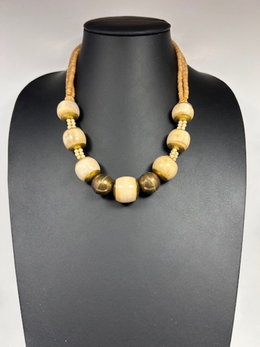 Bone and brass necklace with polished stone details